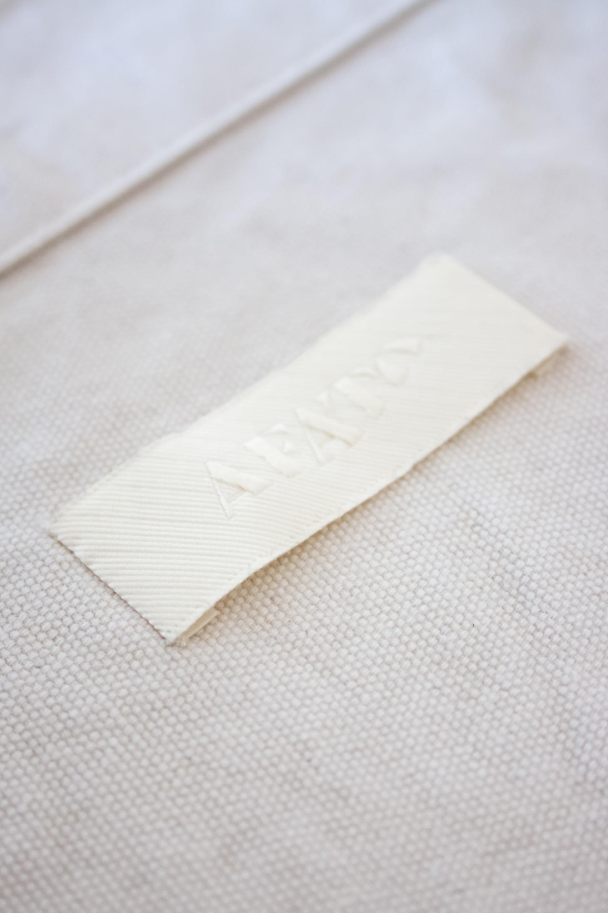 AFATO beachbag label – a symbol of stylish, sustainable beach accessories designed for surf lovers.