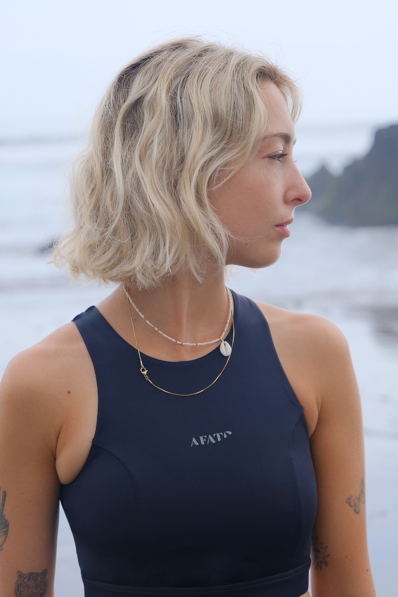 AFATO surf bikini top with zip closure on back and logo print on front, offering secure support for every wave.