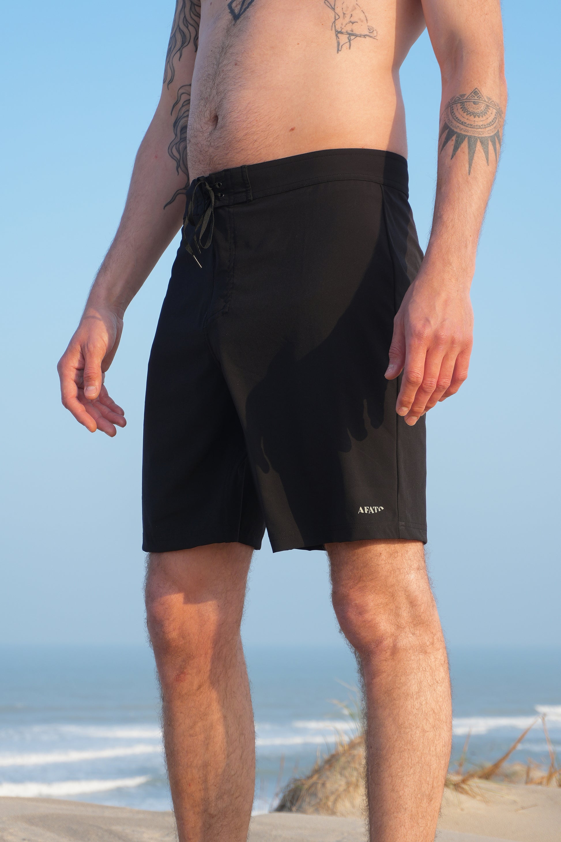 AFATO boardshorts in black – front view showcasing a minimal and functional surfwear design for performance and comfort.