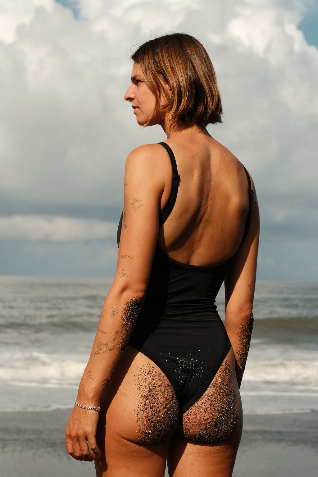 AFATO Oceansuit in black – back view highlighting the minimal and streamlined surfwear silhouette.