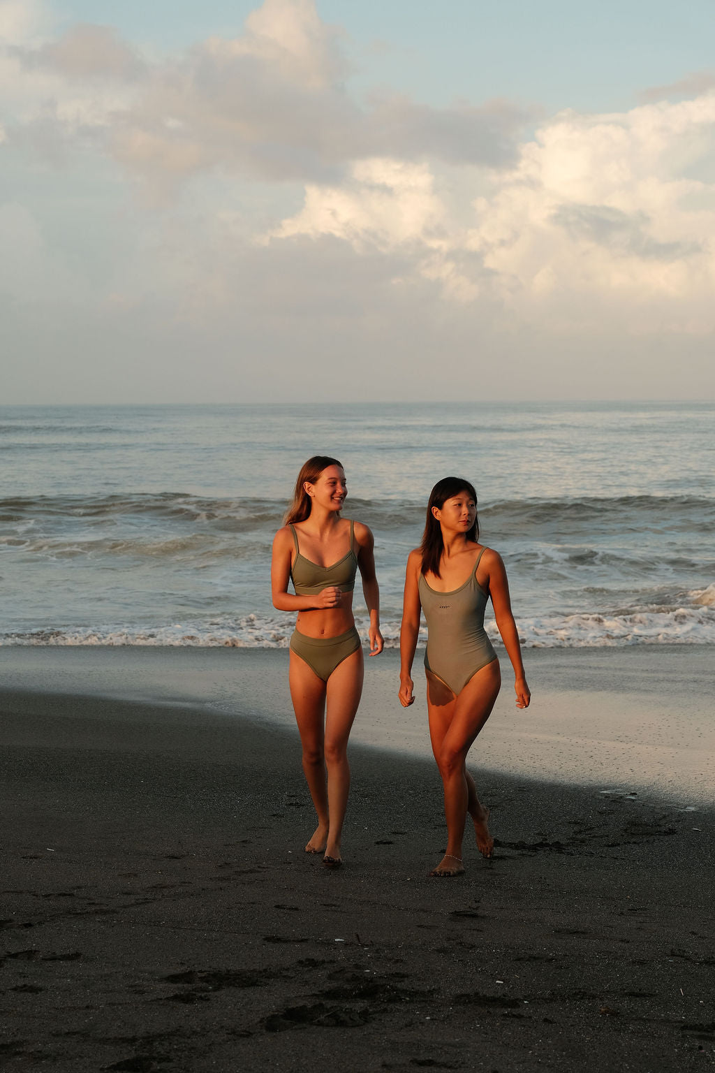Two models wearing AFATO Surfwear in sage green – showcasing a modern surfwear aesthetic and ocean-inspired lifestyle.