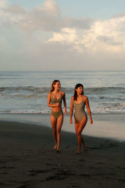 Two models wearing AFATO Surfwear in sage green – showcasing a modern surfwear aesthetic and ocean-inspired lifestyle.