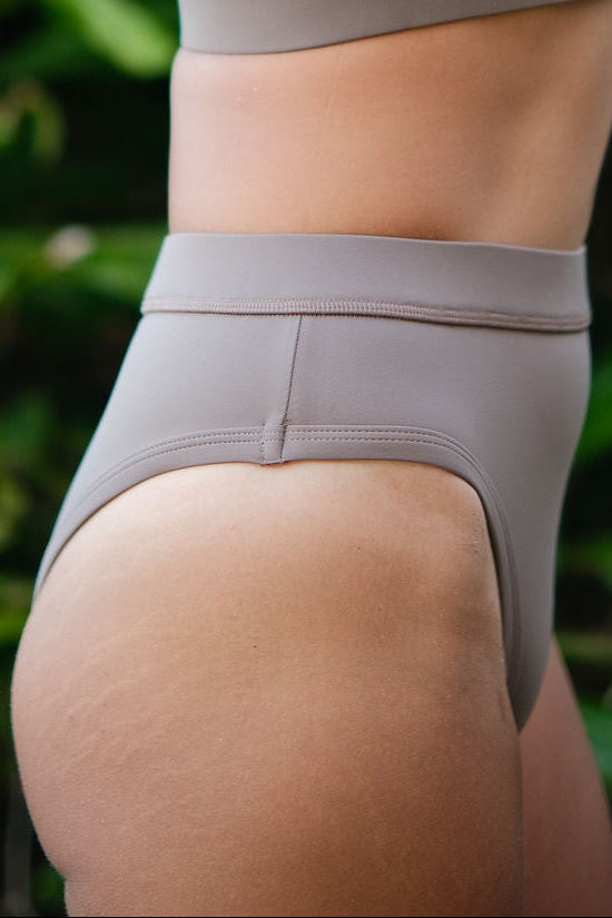 Close-up of AFATO Rise Leg Bottom in mocha fabric – highlighting soft texture, stretch, and premium surfwear quality.