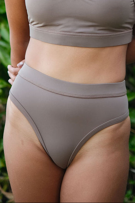 AFATO Rise Leg Bottom in mocha – front view showcasing a high-cut surfwear bikini bottom with a sleek and flattering fit.
