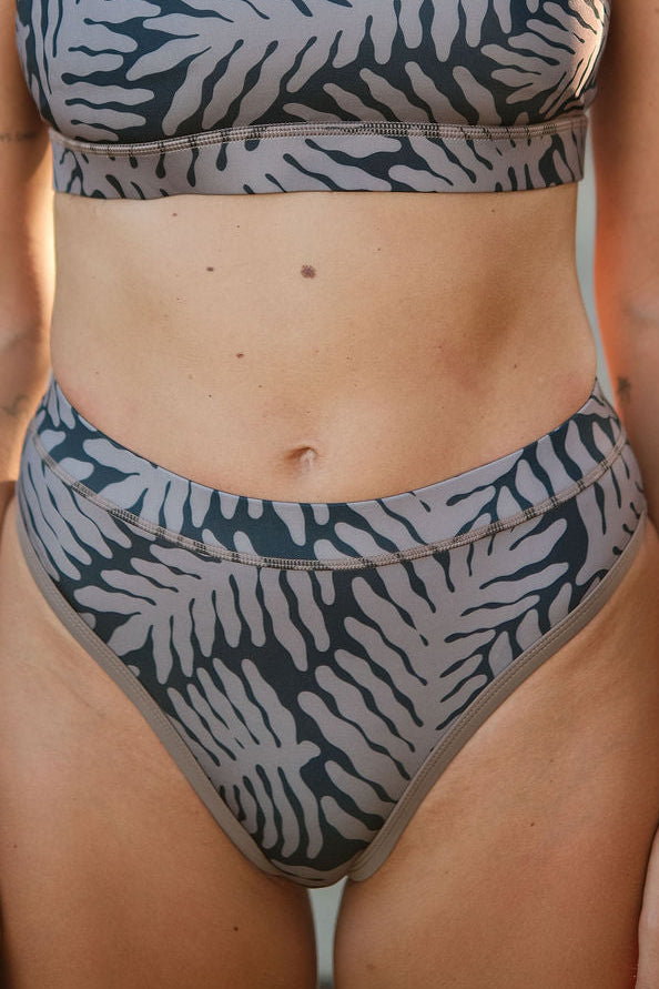 Close-up of AFATO Rise Leg Bottom Palm Rhythm print – detailed tropical palm-inspired surfwear graphic.