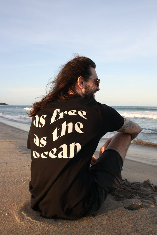 Stylish AFATO unisex shirt with ocean quote – 'As Free As The Ocean' – ideal for a casual, comfortable beach look.